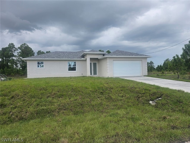 view of front of home featuring a garage and a front lawn