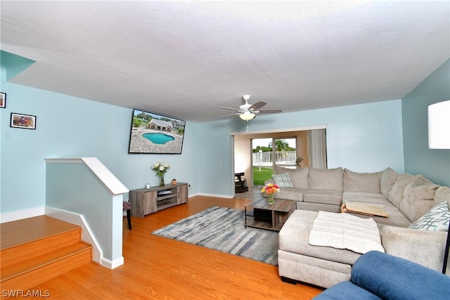 living room with wood-type flooring and ceiling fan