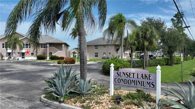 community / neighborhood sign with a yard