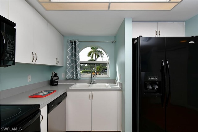 kitchen featuring white cabinets, sink, and black appliances