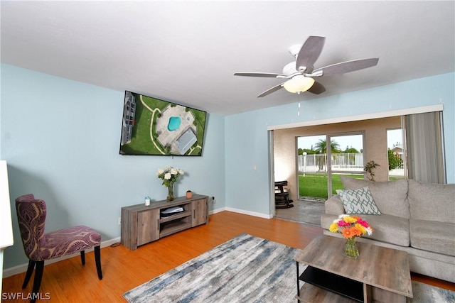 living room featuring wood-type flooring and ceiling fan