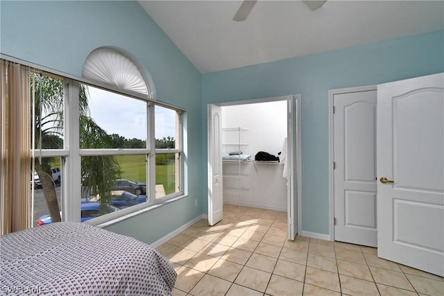 tiled bedroom with lofted ceiling and ceiling fan