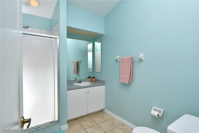 bathroom featuring tile patterned floors, toilet, an enclosed shower, and vanity