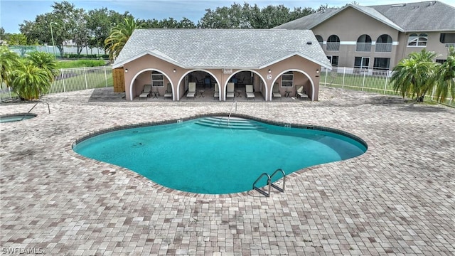 view of swimming pool with a community hot tub and a patio area