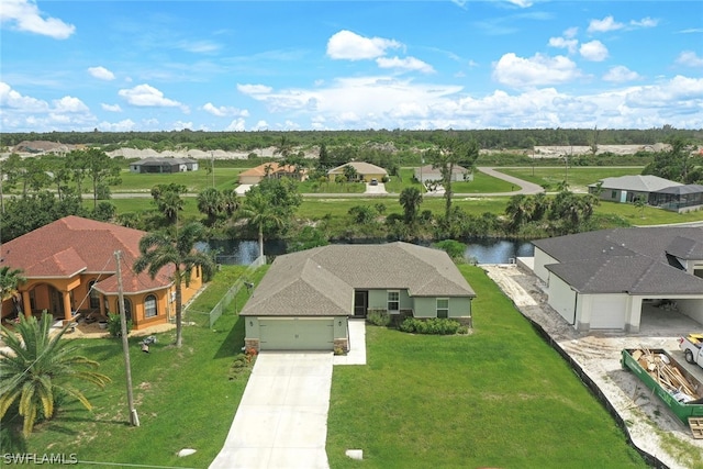 birds eye view of property with a residential view and a water view