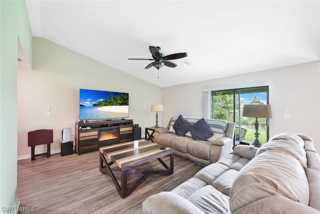 living room featuring lofted ceiling, hardwood / wood-style floors, and ceiling fan