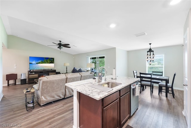 kitchen featuring light hardwood / wood-style floors, sink, lofted ceiling, and pendant lighting