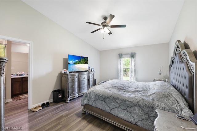 bedroom with ensuite bath, dark wood-type flooring, ceiling fan, and lofted ceiling