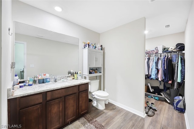 bathroom featuring vanity, toilet, and hardwood / wood-style floors