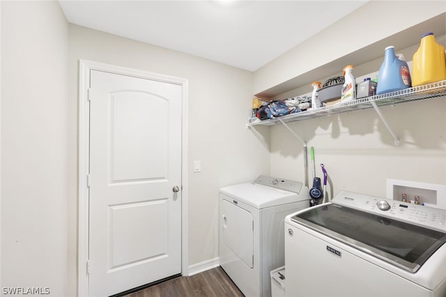 clothes washing area with separate washer and dryer and dark hardwood / wood-style flooring