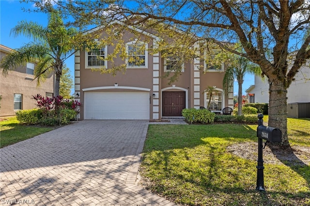 view of front of home featuring a garage and a front lawn