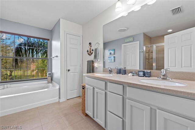 bathroom featuring tile patterned floors, plus walk in shower, and vanity