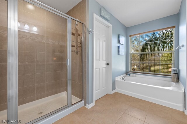 bathroom featuring tile patterned flooring and plus walk in shower