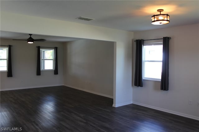 spare room featuring dark hardwood / wood-style flooring and ceiling fan