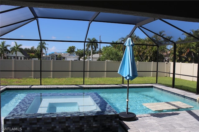 view of pool with an in ground hot tub and a lanai