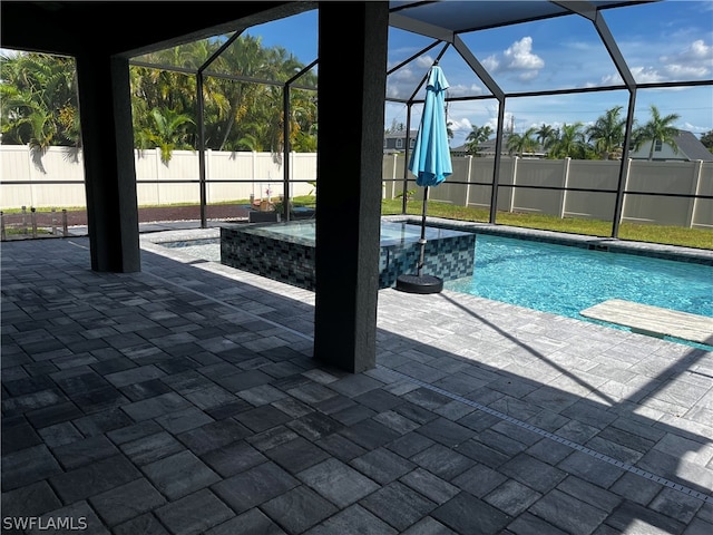 view of swimming pool with a lanai and a patio area