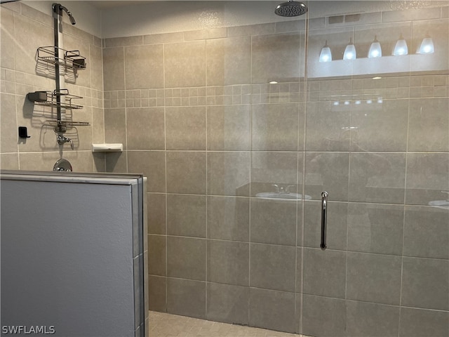 bathroom featuring a shower with shower door