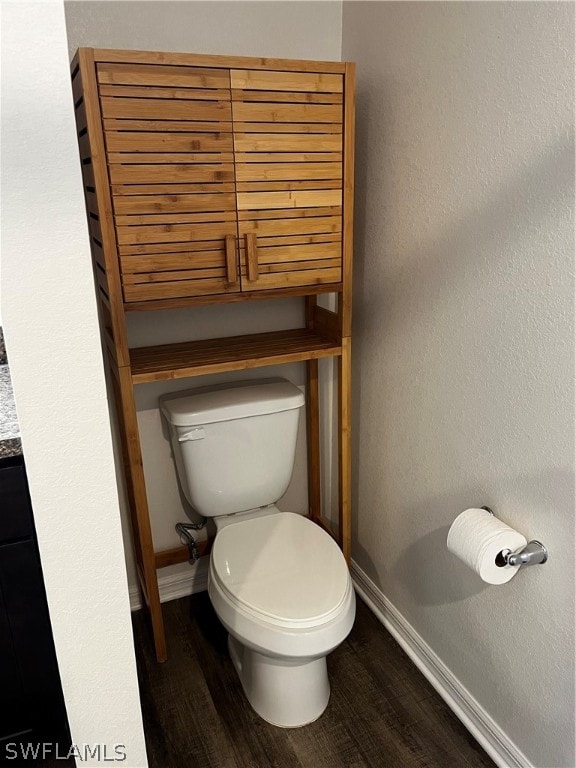 bathroom featuring hardwood / wood-style flooring and toilet