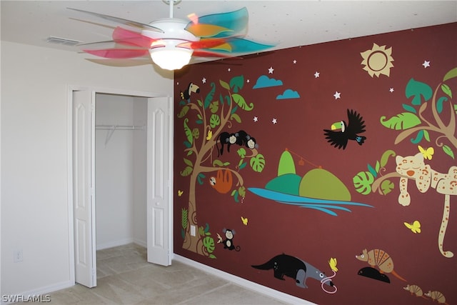 bedroom with a closet, carpet floors, and ceiling fan