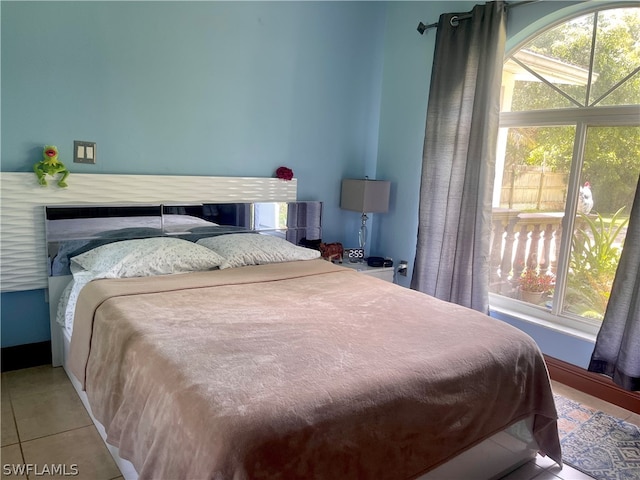 tiled bedroom with multiple windows