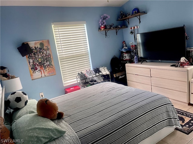 tiled bedroom with lofted ceiling