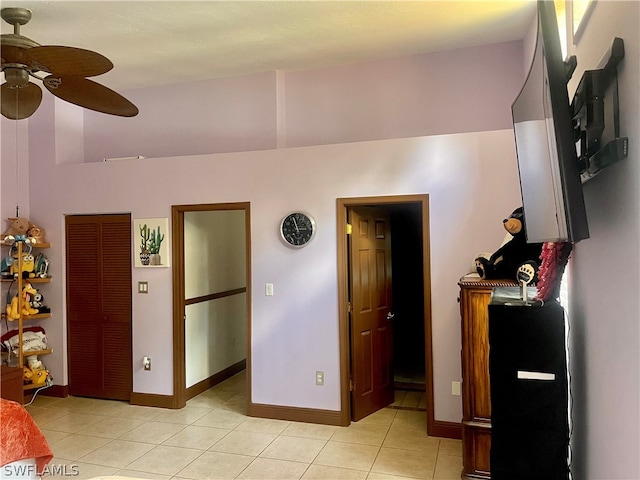 interior space with ceiling fan and tile patterned flooring