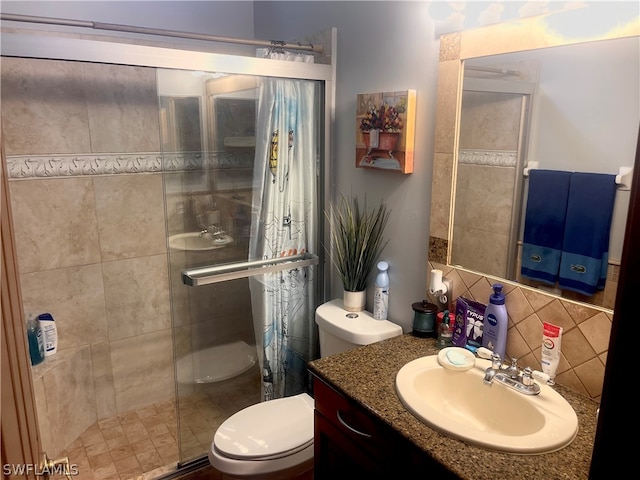 bathroom featuring tile walls, a tile shower, backsplash, toilet, and vanity