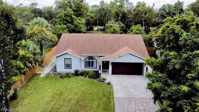 view of front of home featuring a garage and a front lawn