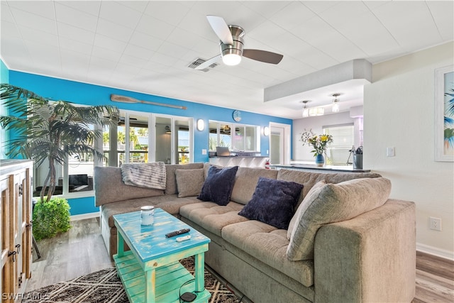 living room with ceiling fan and hardwood / wood-style floors