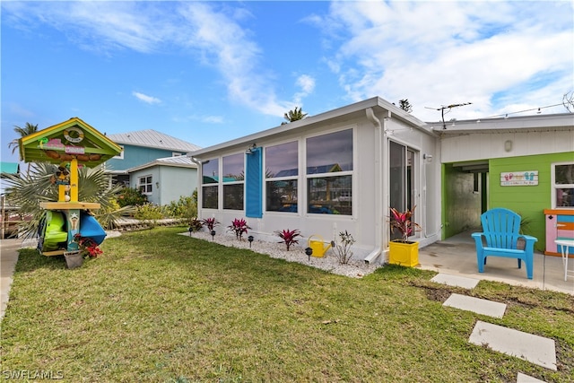 rear view of house with a yard