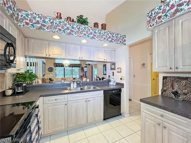 kitchen featuring white cabinetry, sink, light tile patterned floors, and black appliances