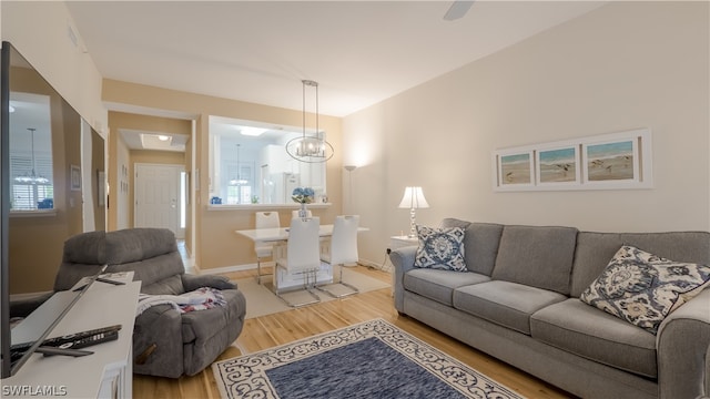 living room featuring an inviting chandelier and hardwood / wood-style floors