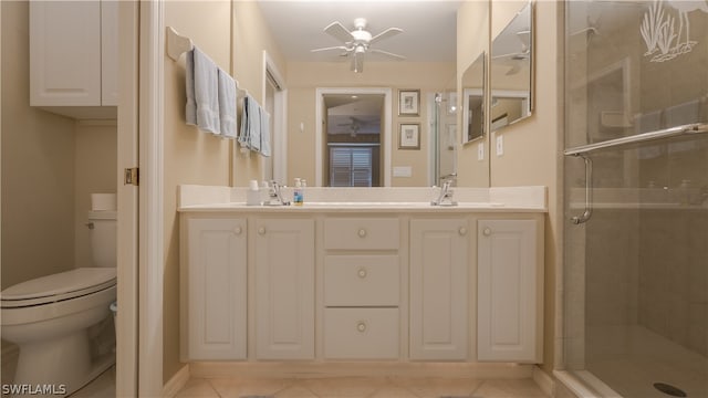 bathroom featuring double vanity, an enclosed shower, toilet, tile patterned floors, and ceiling fan