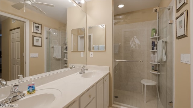 bathroom with double vanity, walk in shower, and ceiling fan