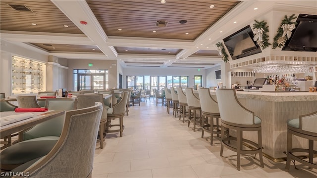 bar featuring beamed ceiling, coffered ceiling, and light tile patterned floors