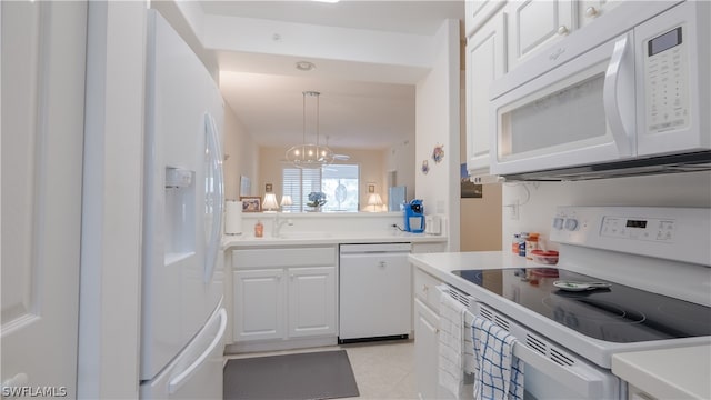 kitchen with a notable chandelier, white cabinetry, hanging light fixtures, white appliances, and light tile patterned floors