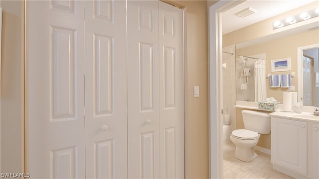 full bathroom with tile patterned flooring, shower / bath combo, toilet, and vanity