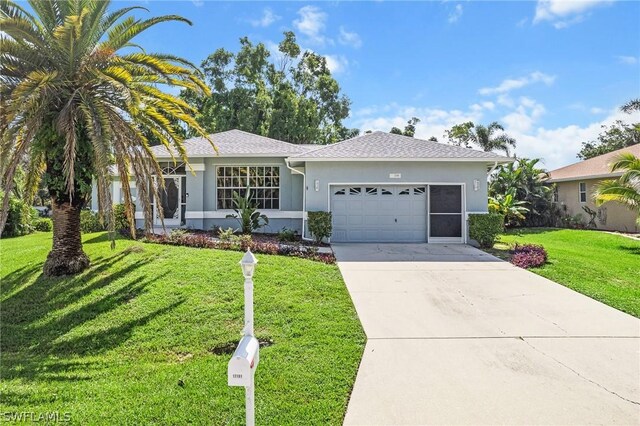 ranch-style house featuring a garage and a front lawn