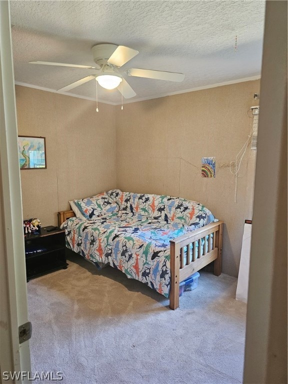 bedroom with carpet, a textured ceiling, and ceiling fan