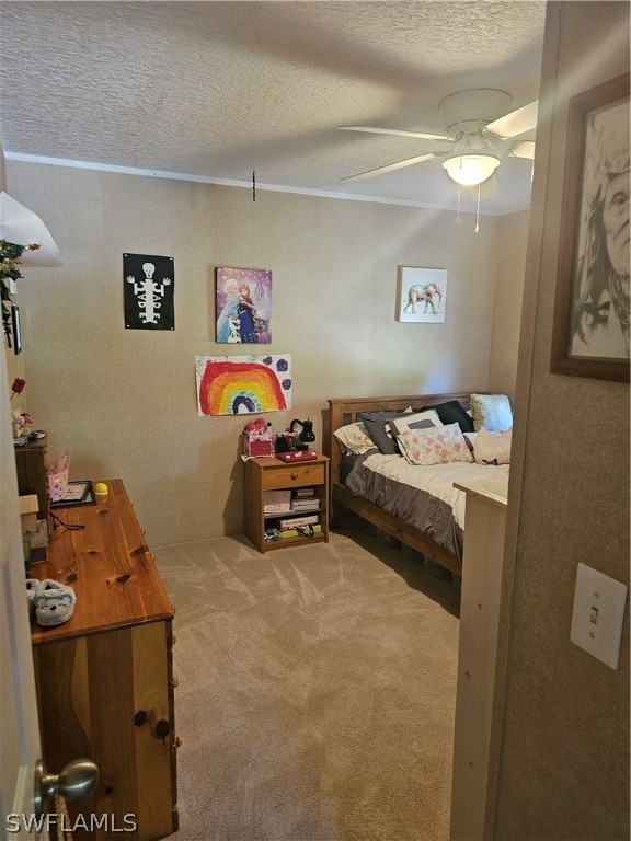 carpeted bedroom with a textured ceiling and ceiling fan