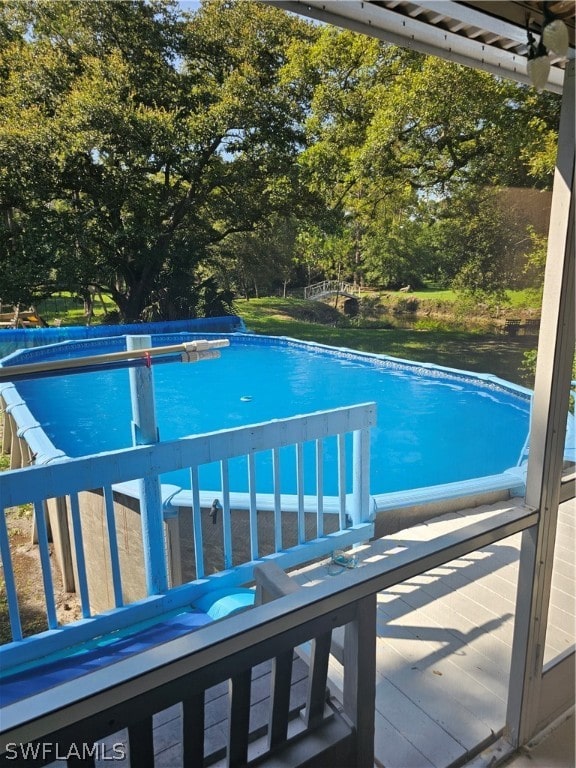 view of swimming pool with a wooden deck