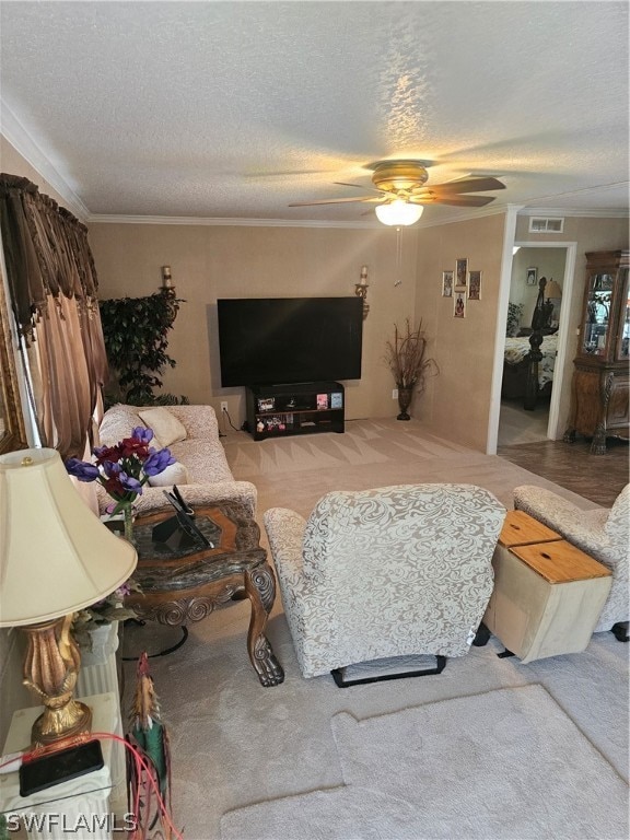 carpeted living room with crown molding, a textured ceiling, and ceiling fan