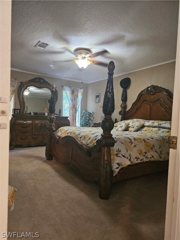 carpeted bedroom with a textured ceiling, crown molding, and ceiling fan