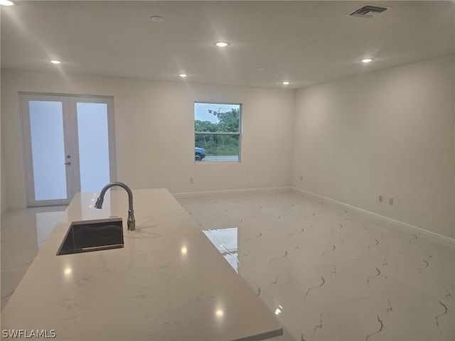 kitchen with recessed lighting, a sink, visible vents, marble finish floor, and light stone countertops