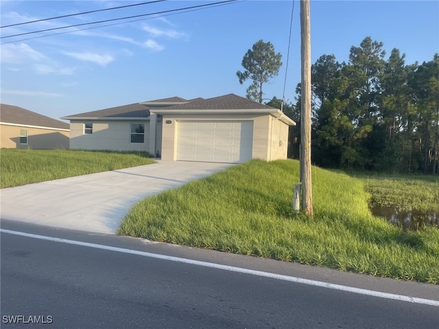 view of front of property with driveway and a garage