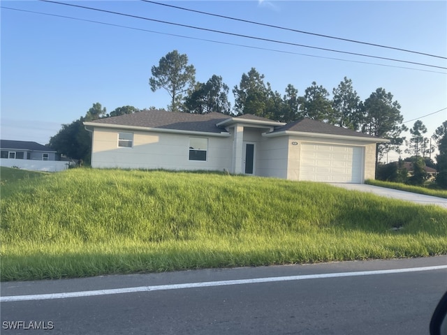 ranch-style house featuring driveway and an attached garage