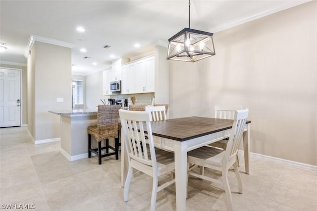 dining area with light tile patterned flooring, crown molding, and a notable chandelier