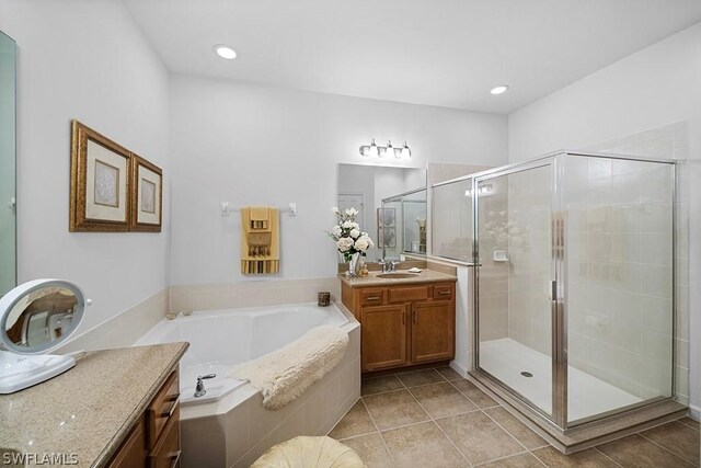 bathroom with vanity, independent shower and bath, and tile patterned flooring