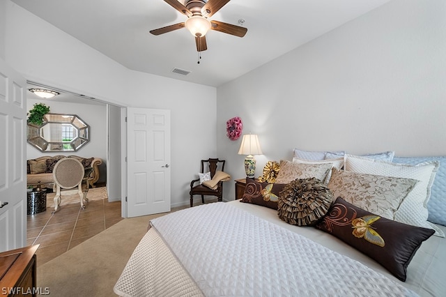 tiled bedroom with ceiling fan