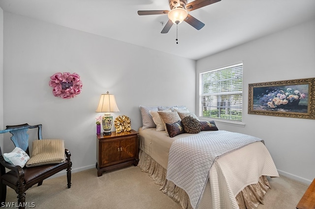 bedroom with ceiling fan and light carpet